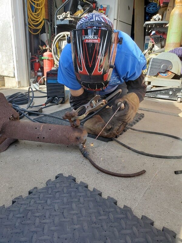 Dave welding Spot's tail back on